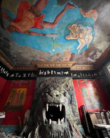 Inside Ron's Place, incredible colourful murals cover the walls and the centrepiece is the plaster face of a lion, roaring