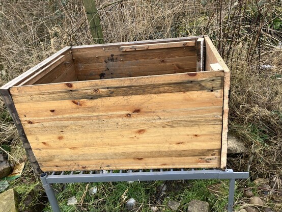 A wooden box on a metal frame