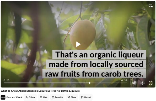 Video that goes with a Food and Wine story "What to Know about Monaco's Luxurious Tree-to-Bottle Liqueurs". The screen shows what appears to be a mango and text in the video about Carruba says "That's an organic liqueur made from locally sourced raw fruits from carob trees."