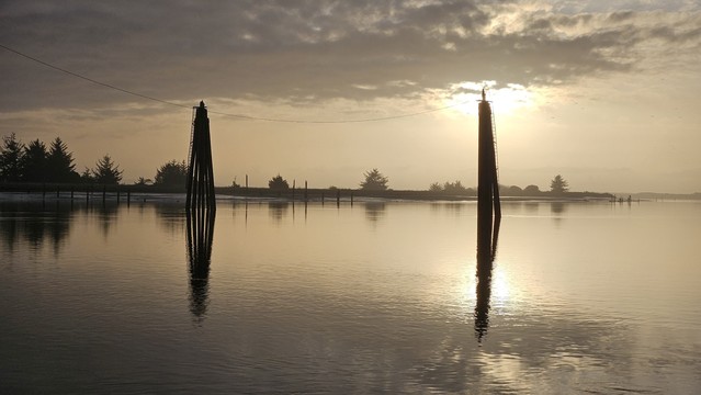 two bridge protection bents, in the river, at sunset