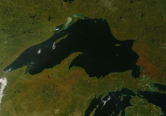 image/jpeg a satellite image shows the dark waters of Lake Superior with the greens and bronze colours of the land surrounding it. Public Domain. MODIS satellite image.